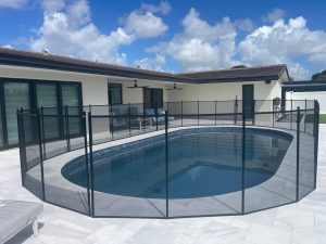 Child-safe mesh pool barrier surrounding a residential swimming pool in Pembroke Pines, FL