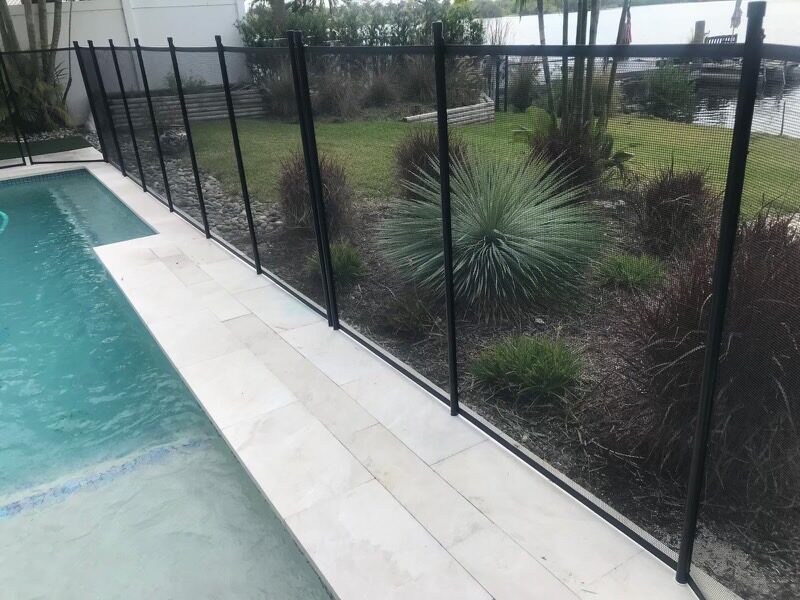 Pool fence Coral Springs guide example: mesh panels between a pool deck and landscaping
