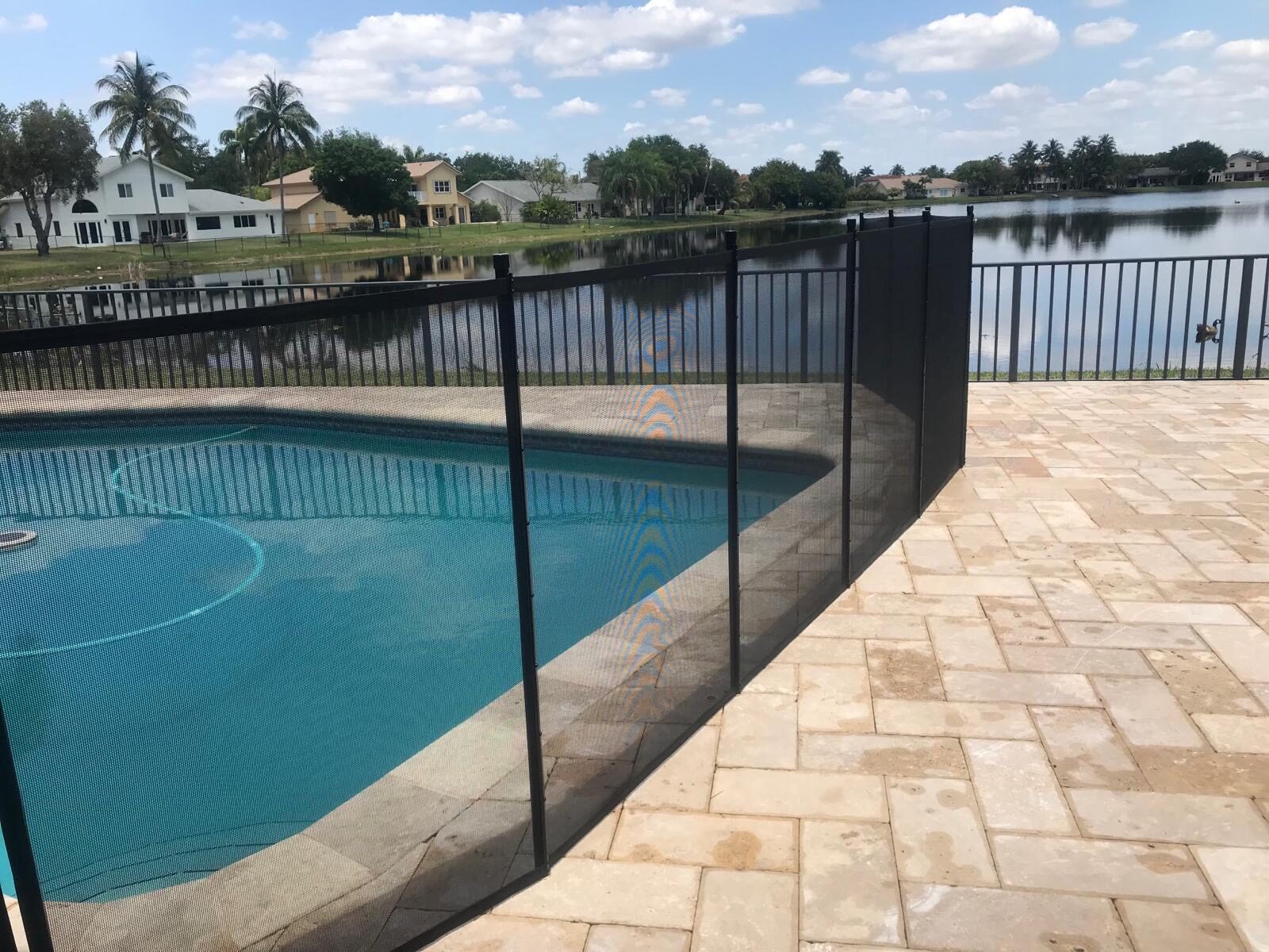 Coral Springs pool statistics guide illustration: mesh pool fence beside a waterfront deck