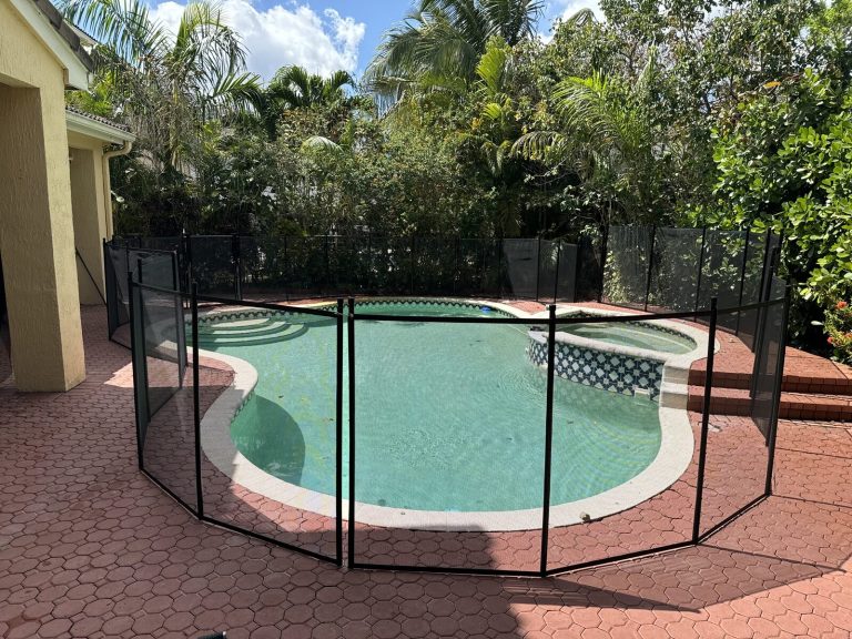 Installed mesh pool fence beside a Pembroke Pines swimming pool before any pool fence storage