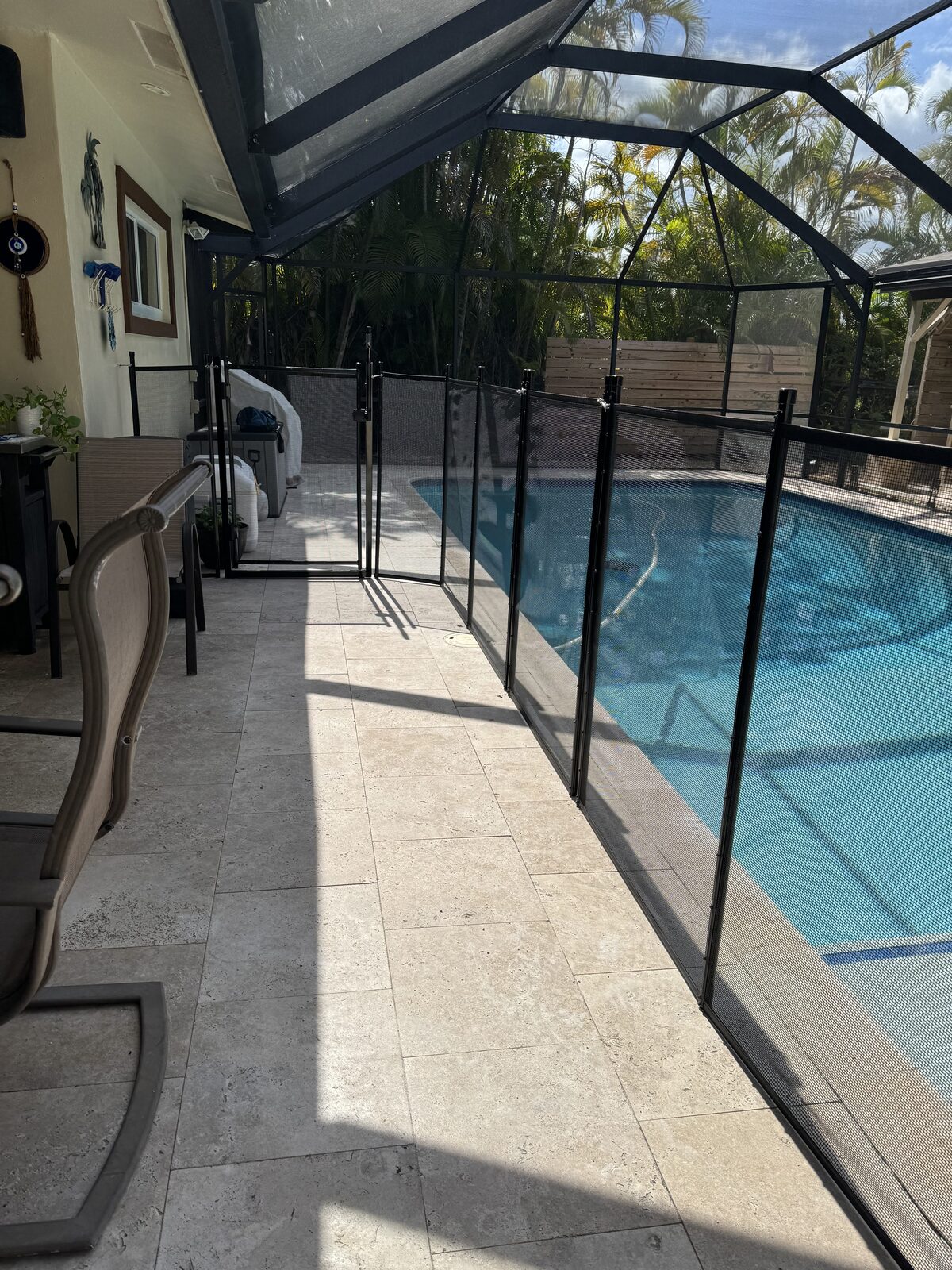 Barrier layout for pool alarms planning: mesh fence along a screened patio walkway leading to a Plantation gate